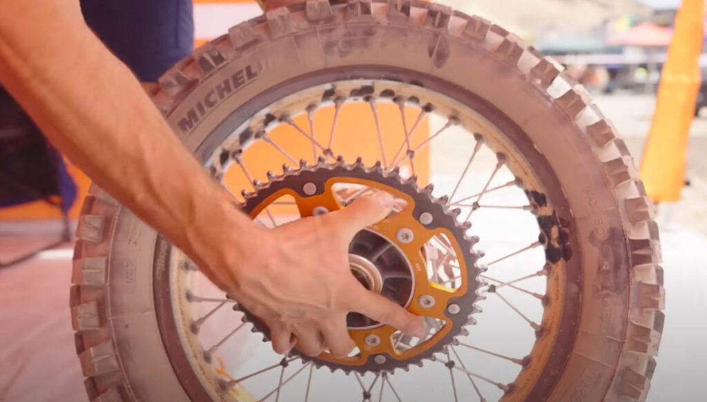 Servicing a KTM 450 factory rally motorcycle mid-race